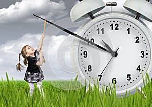 Little child pulling hand clock, time stop concept