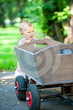 Little child push old wagon trolley