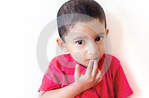 little child putting finger on mouth with small hairs