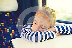 Little child sleeping in a train. Travel, traveling with small children. Cute boy is traveling on the train