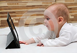 Little child touching his tablet computer