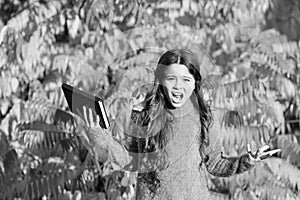 Little child unhappy learning in autumn park. Kid study with book. Keep studying. Small girl read book on autumn day