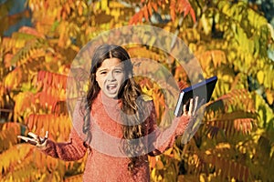 Little child unhappy learning in autumn park. Kid study with book. Keep studying. Small girl read book on autumn day