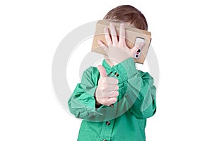 Little child uses virtual reality (VR cardboard) on white background