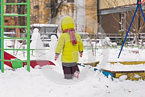 Little child walk on winter playground