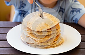 Little child wanting to eat fresh pancaked