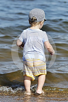 Little child wants to enter into water