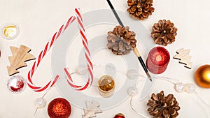 Little child wearing christmas holiday pajamas, doing crafts Christmas tree decorations