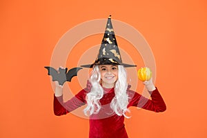 Little child in witch costume. Halloween party. Small girl in black witch hat. Autumn holiday. Join celebration. Magical