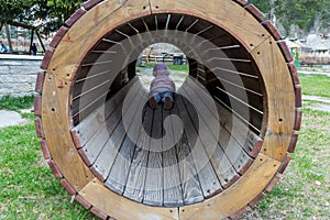 Little child in a wooden tunnel in a playground