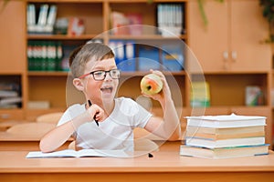 Little child writing with colorful pencils, indoors. Elementary school and education. Kid learning writing letters and numbers