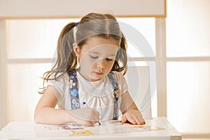 Little child writing letter A