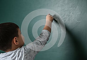 Little child writing math sum