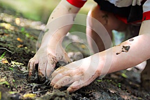 Little Child's Hands Digging in the Mud