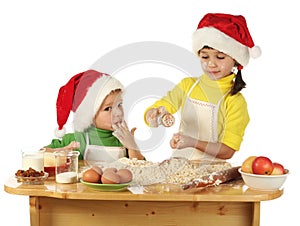 Little children cooking the Christmas cake