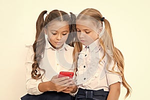 Little children depend on mobile phone. Girls text sms with mobile phone. depend. photo