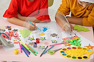 Little children drawing at table indoors. Christmas season