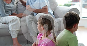 Little children listening to their parents fighting on the couch