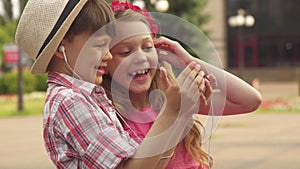 Little children play with smartphone outdoors