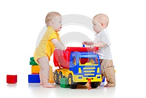 Little children playing with color toys