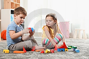 Little children playing with colorful blocks
