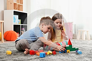 Little children playing with colorful blocks