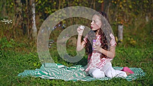 Little children playing in the garden with soap bubbles