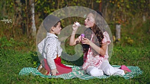 Little children playing in the garden with soap bubbles