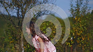 Little children playing in the garden with soap bubbles