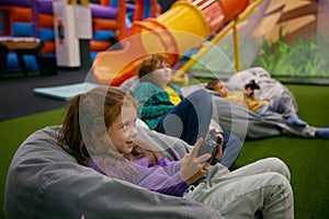 Little children playing video game in entertainment center