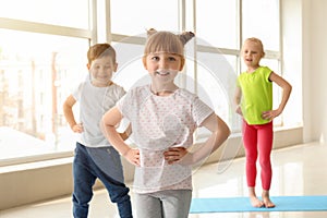 Little children practicing yoga indoors