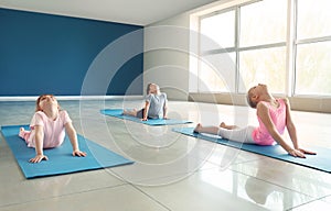 Little children practicing yoga indoors