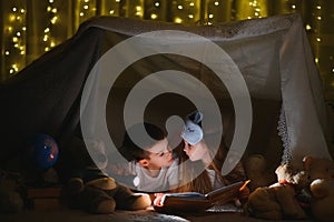 Little children reading bedtime story at home