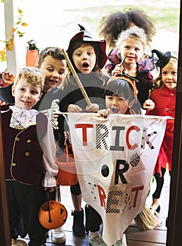 Little children trick or treating on Halloween