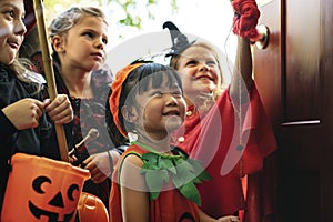 Little children trick or treating on Halloween