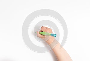 Little chilld`s hand holds a pen photo