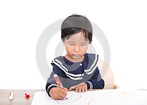 Little Chinese girl practiced drawing seriously at the table photo