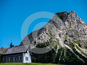 little christian church or chapel in mountain scenery, switzerland alps