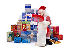 Little Christmas boy along gifts with wishlist