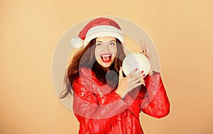 Little Christmas magic. morning before xmas. winter holidays and vacation. woman in down jacket. girl santa hat. padded