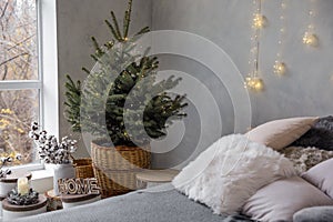 Little Christmas tree with fairy lights in bedroom