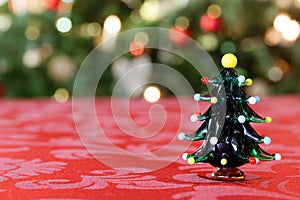 Little Christmas Tree Figure in Front of Christmassy Background