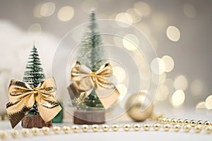 Little Christmas trees decorated and gifts for the new year on the bokeh background, new year mood 2021