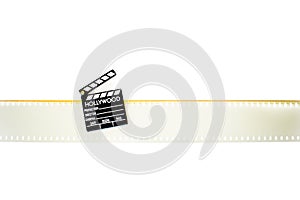 Little clapper board on empty 35 mm movie filmstrip isolated