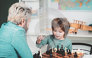 Little clever boy thinking about chess. Chess success and winning. Back to school. Cute boy developing chess strategy
