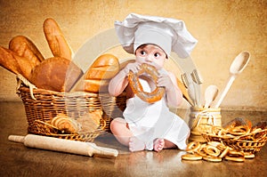 Little cook with a bagel in her hands