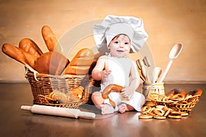 Little cook with a bagel in her hands.