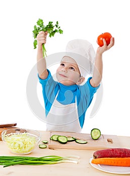 Little cook with parsley and tomatoes
