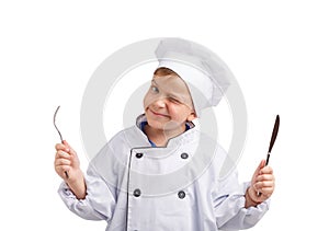 Little cook with fork and knife in hands on a white isolated background