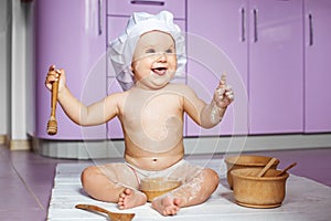 Little cook with wooden utensils. Game. The concept of childhood